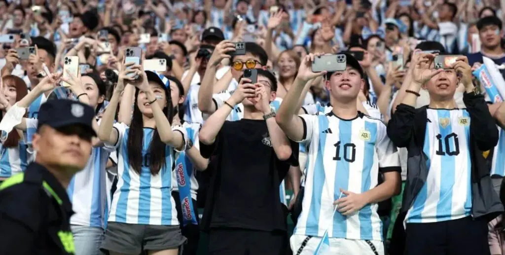 Gen Z fans standing for FIFA World Cup game